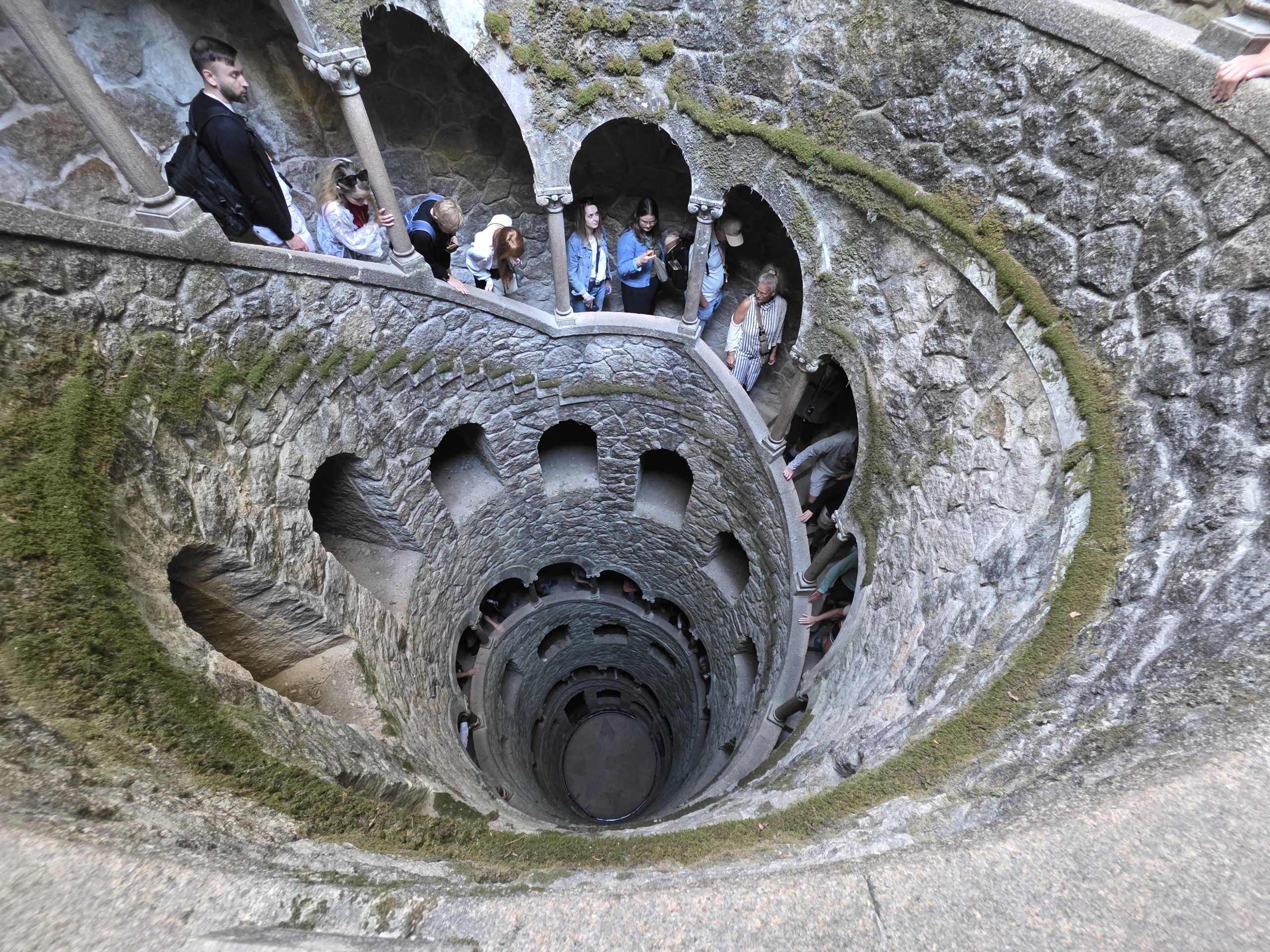 Spiral stairway descending around the stone shaft of the Initiation Well.