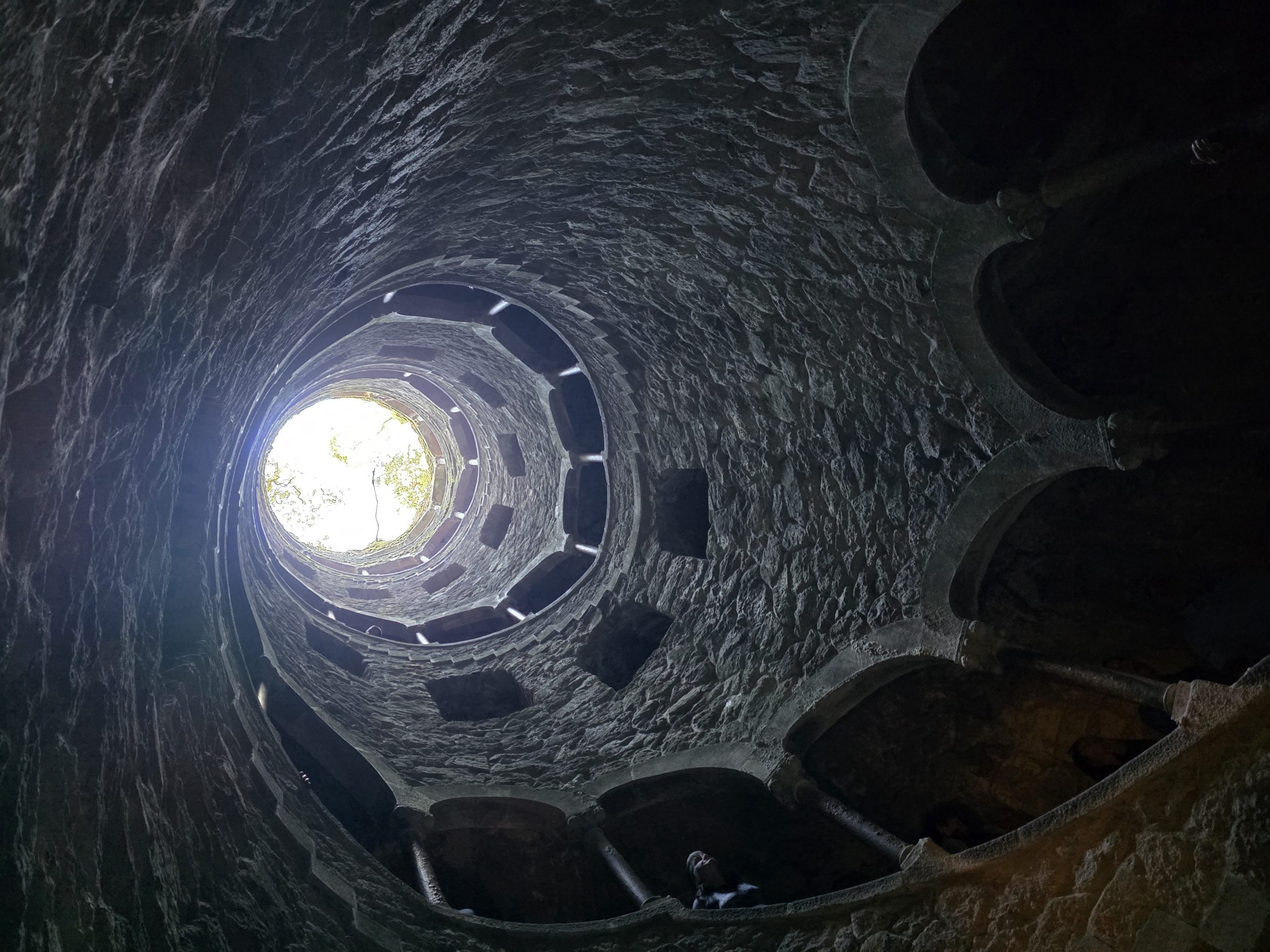 Circular opening to the sky above the stone arches of the Initiation Well.